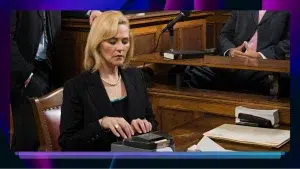 A stenographer transcribing legal activities on a steno machine in a courtroom.