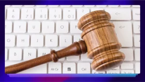 A courtroom gavel resting on a keyboard.