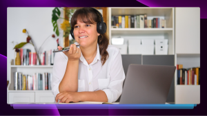 A woman in headphones speaking into a cell phone voice recorder.